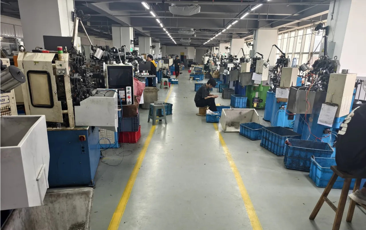 Skilled workers operating CNC machinery on the akgnx Co.,ltd production floor